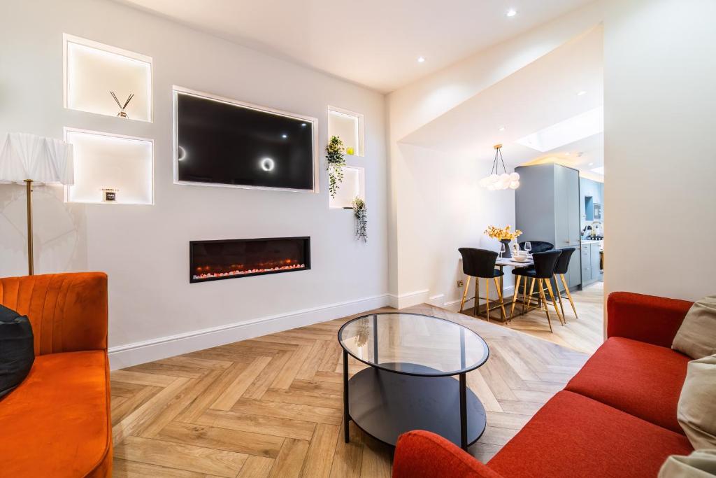 a living room with a couch and a fireplace at Livestay-Luxury Kentish Town Apartments in London