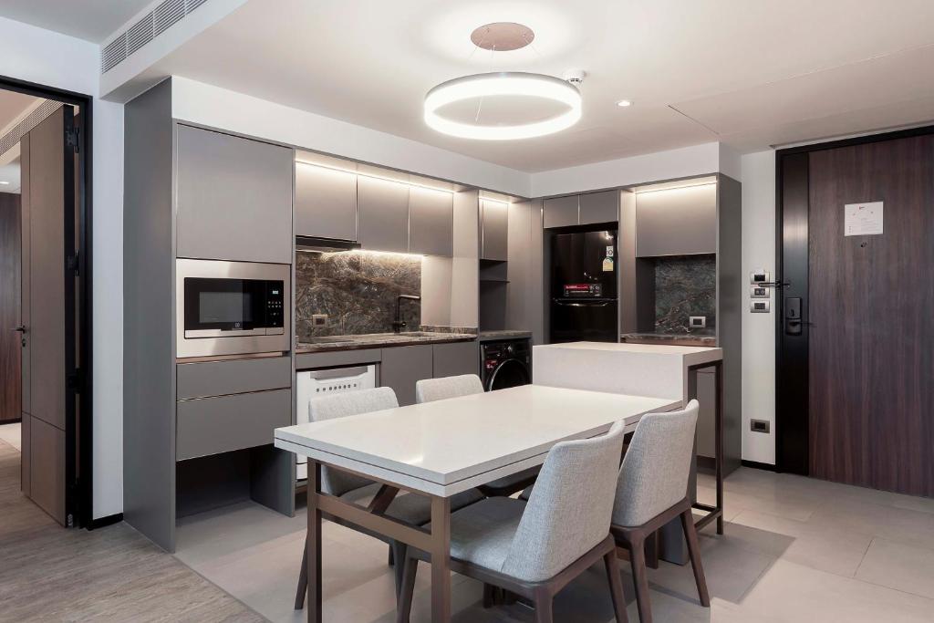A dining and kitchen zone with integrated appliances and a compact entrance area.