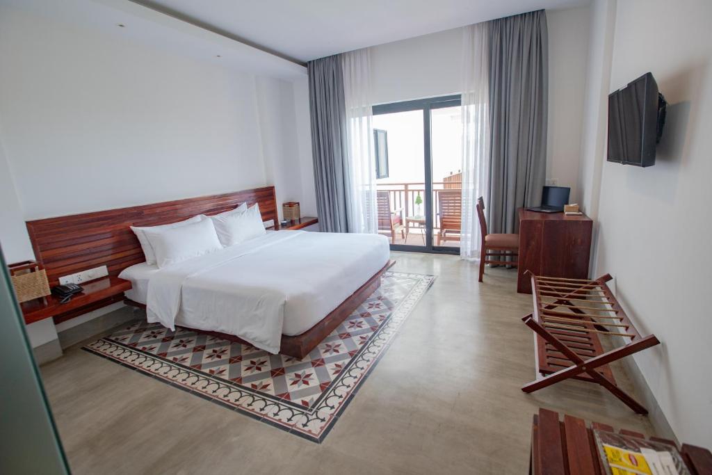 Postel nebo postele na pokoji v ubytování DACO Hotel