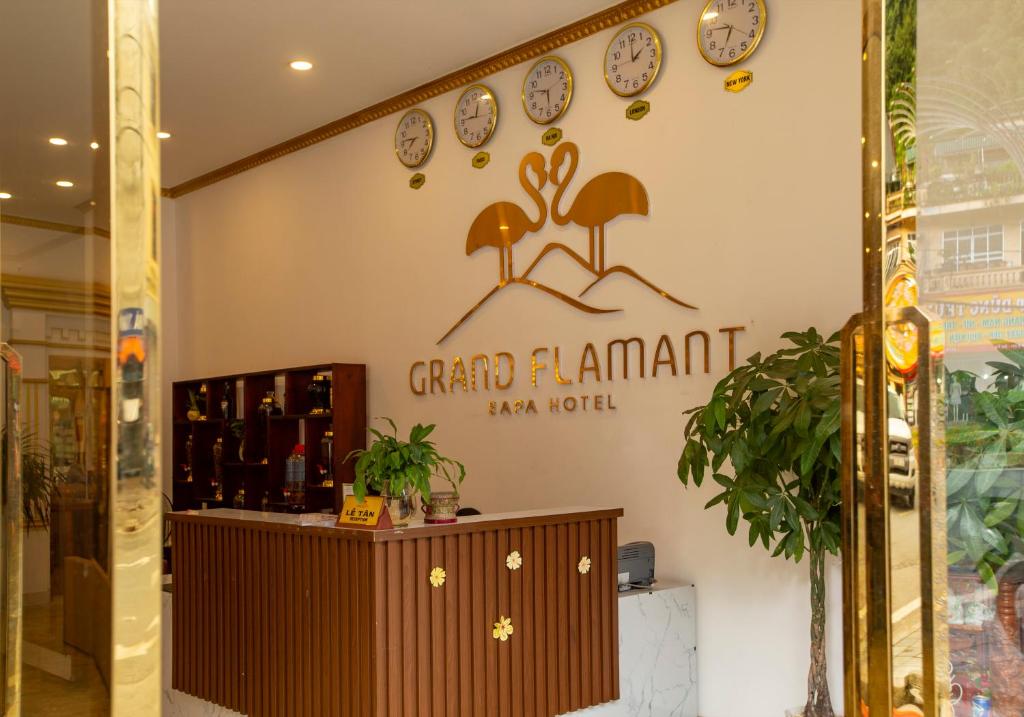 a store with a sign that reads grand island new world at Grand Flamant Hotel Sapa in Sa Pa