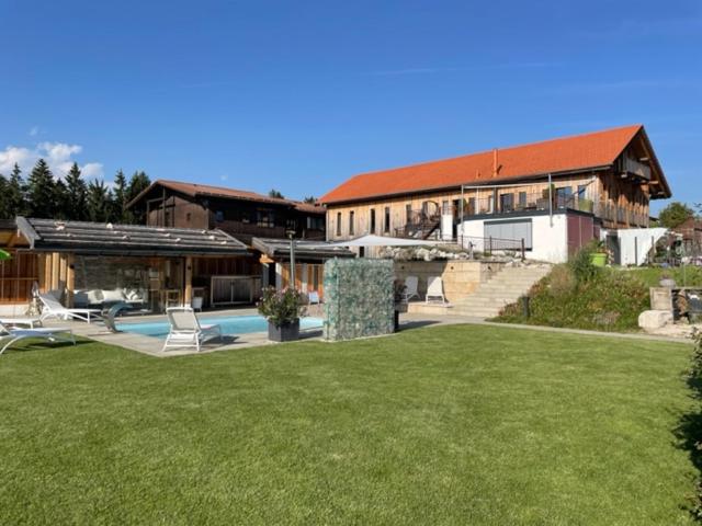 a large house with a swimming pool in a yard at Private Luxury Chalet in Siegsdorf