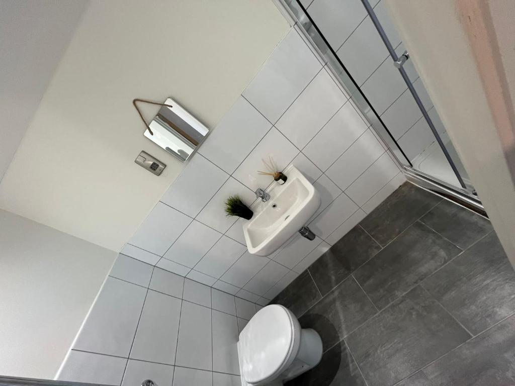 a white bathroom with a toilet and a sink at Bliss Apartments - Contractor 314 in Bradford