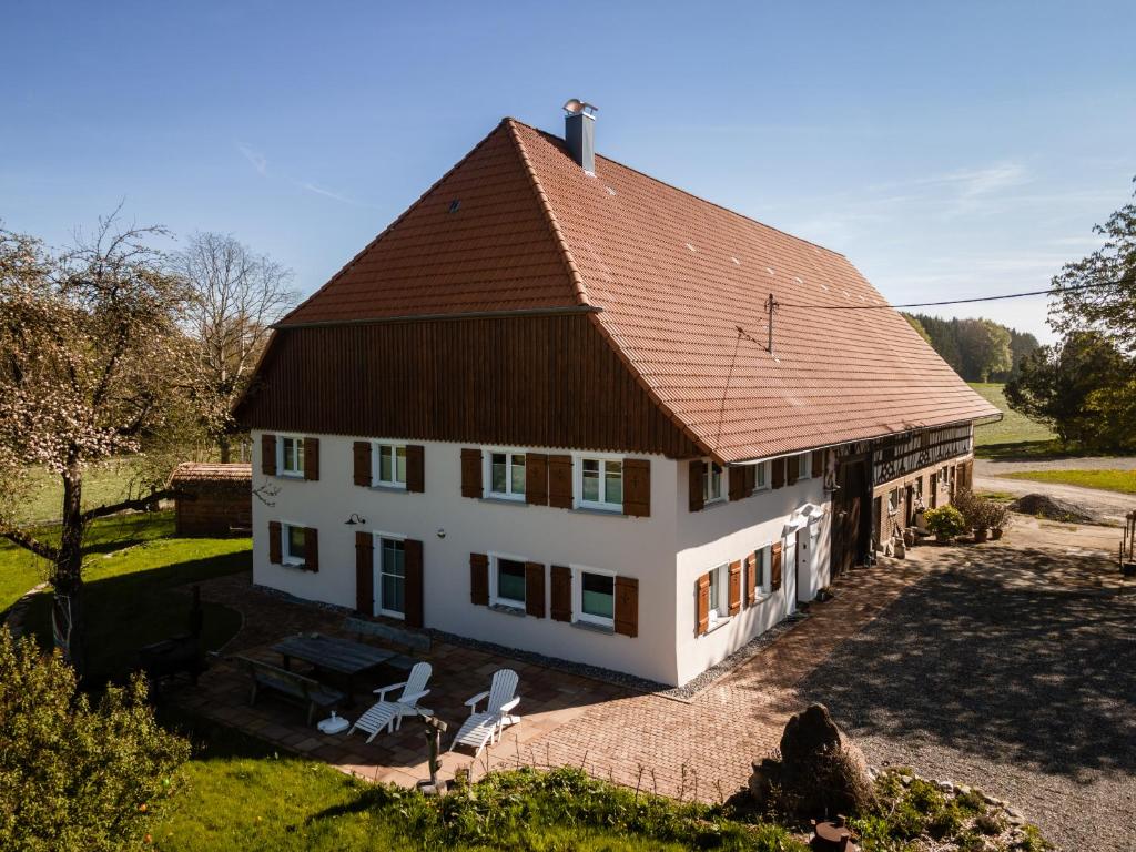 a large white house with a brown roof at Ferienhof Greuthof in Bad Wurzach