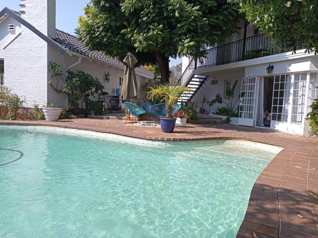 a swimming pool in front of a house at Darrenwood Guesthouse & SPA in Johannesburg