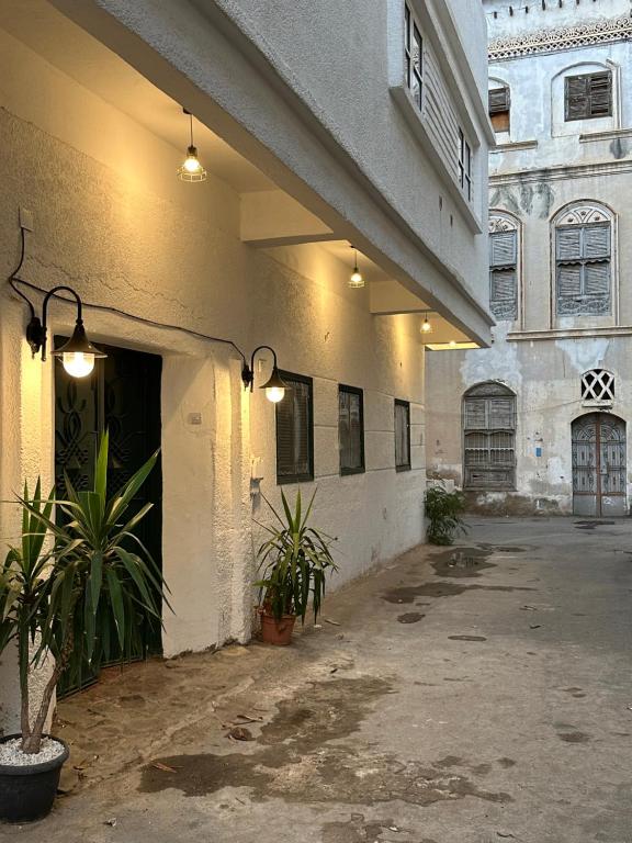 a building with two potted plants in a courtyard at Dar Sayang in Taif