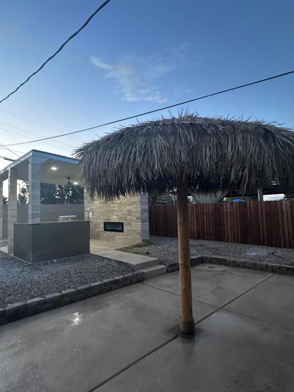 a straw umbrella in front of a building at Charming and Cozy Place in Las Vegas