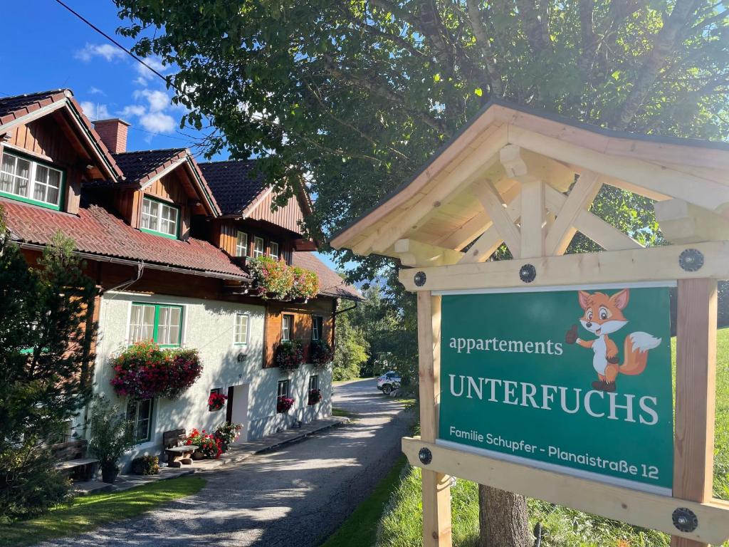 a sign in front of a street with houses at Unterfuchs in Schladming