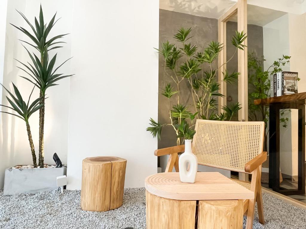 Zimmer mit einem Stuhl, einem Tisch und Pflanzen in der Unterkunft Sleep Box Penang in George Town