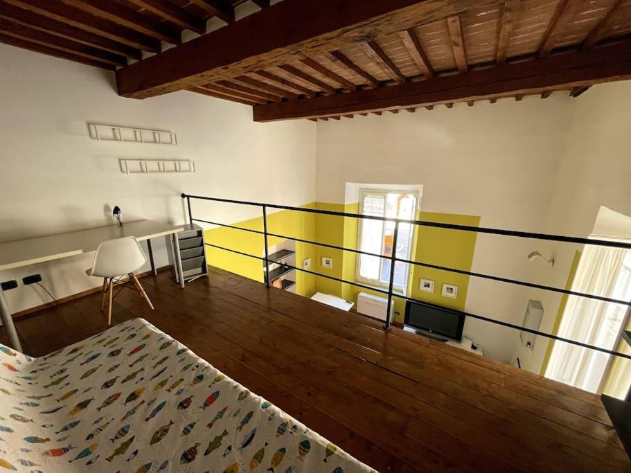 a room with a bed and a yellow and white wall at Loft storico in pieno centro! in Livorno
