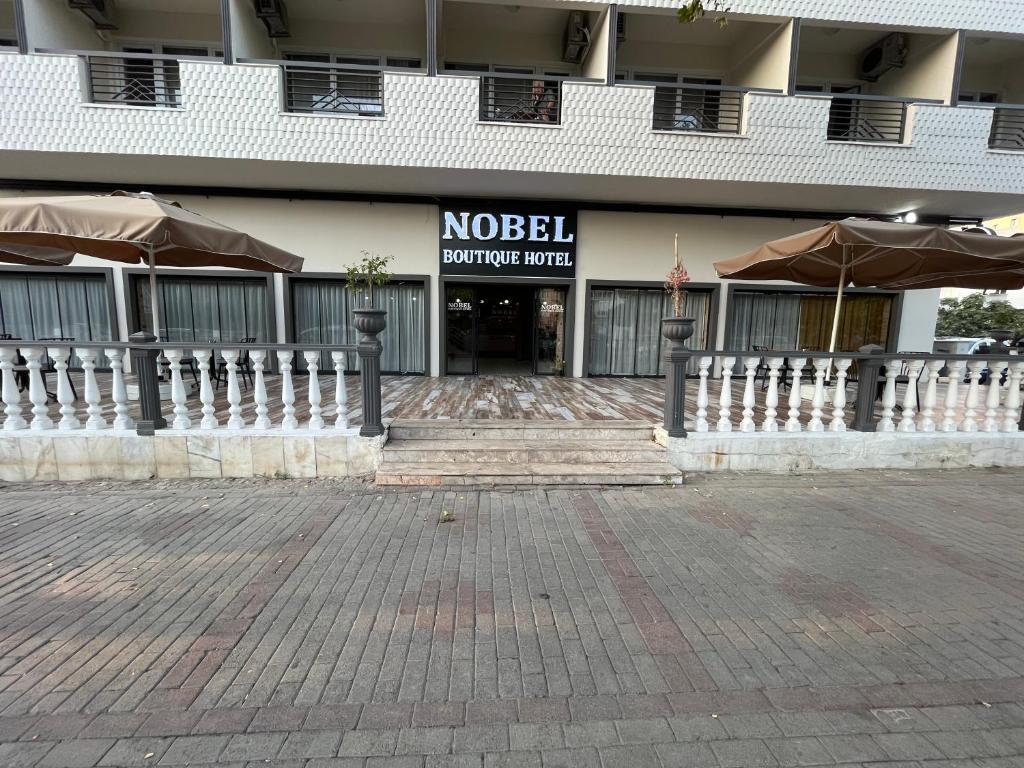 a building with a noel shopping center with umbrellas at Nobel Boutique Hotel in Selçuk