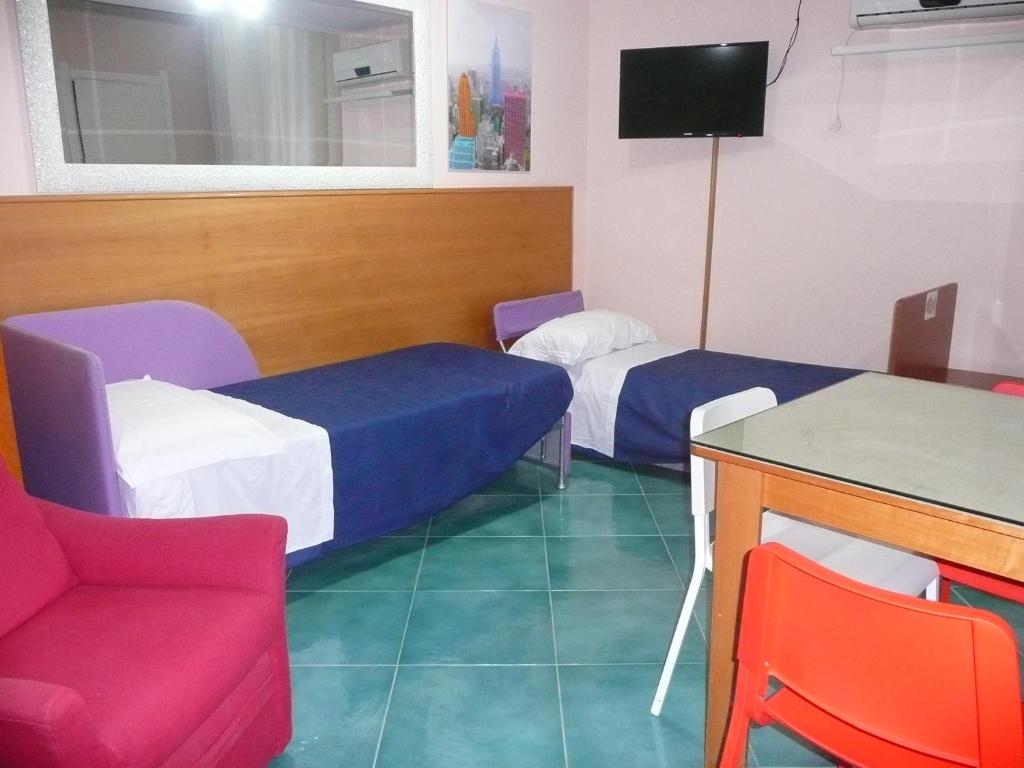 TV a/nebo společenská místnost v ubytování I Papiri B&B Aparthotel