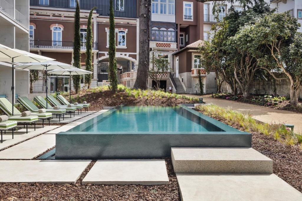 a swimming pool in the middle of a building at One Shot Palácio Cedofeita in Porto