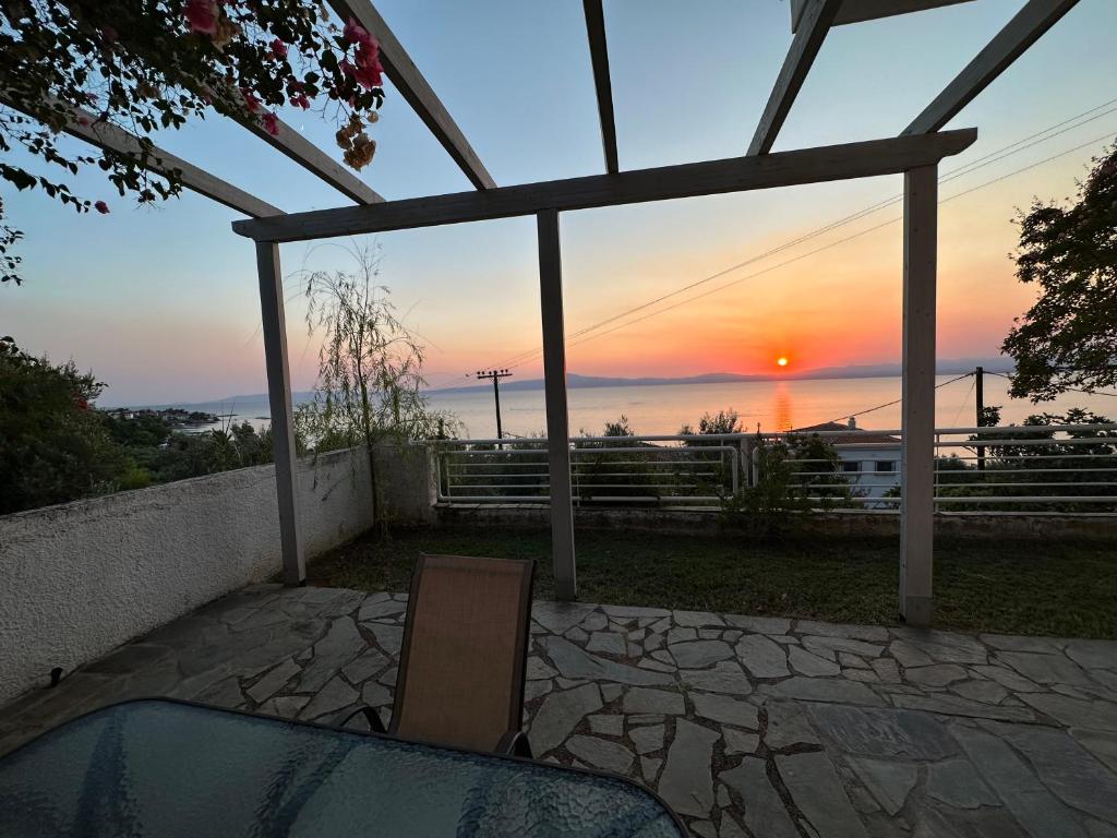 a view of the sunset from the patio of a house at Villa pinelopi in Kalamata