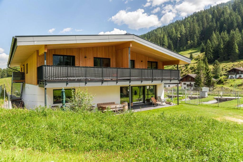una casa en las montañas con un patio en Rehwiese en Obernberg am Brenner