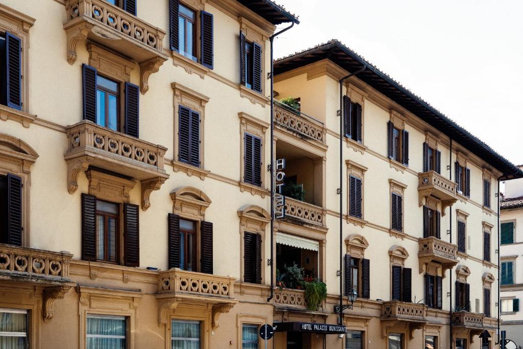 a large building with black windows and balconies at Hotel Palazzo Ognissanti in Florence
