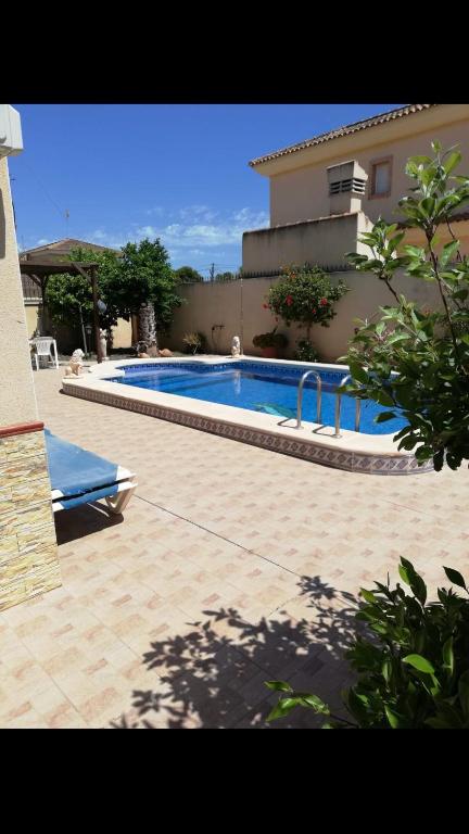 a large swimming pool in front of a house at Spanish Villa in Torre del Rame