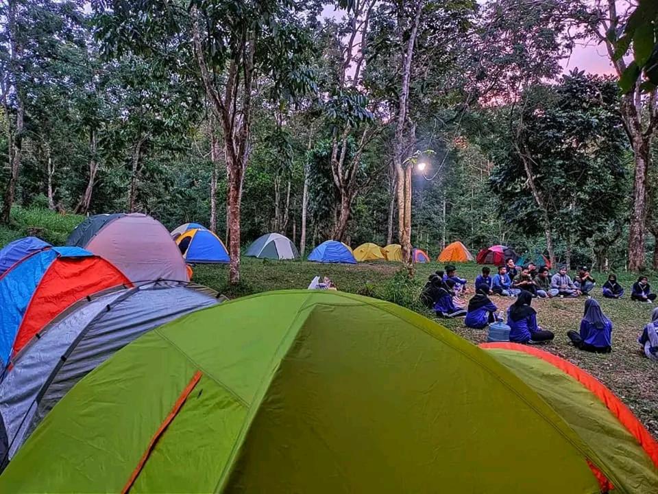 a group of people sitting around a tent at Joben Eco Park in Tetebatu