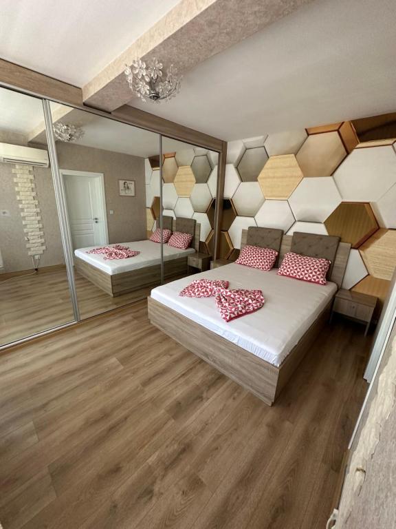two beds in a room with mirrors at Abel Apartment in Pomorie