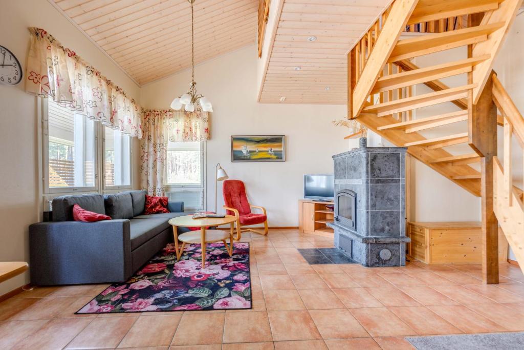 a living room with a couch and a wood stove at Lomahuoneisto Kalajoen Hiekat C 6 in Kalajoki