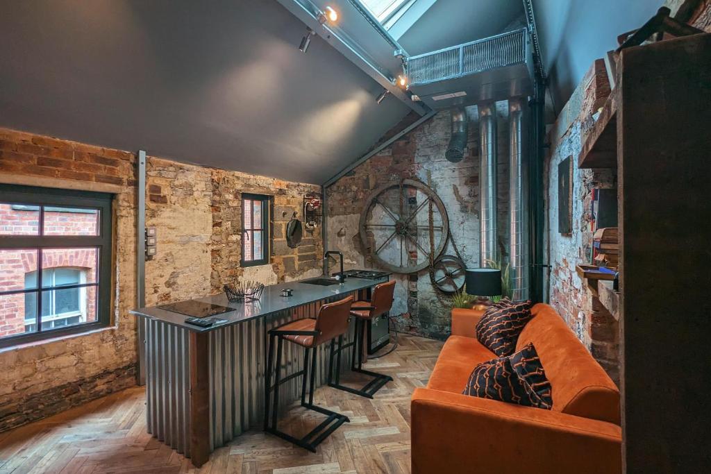 a living room with a couch and a bar in it at Blayds Yard in Leeds