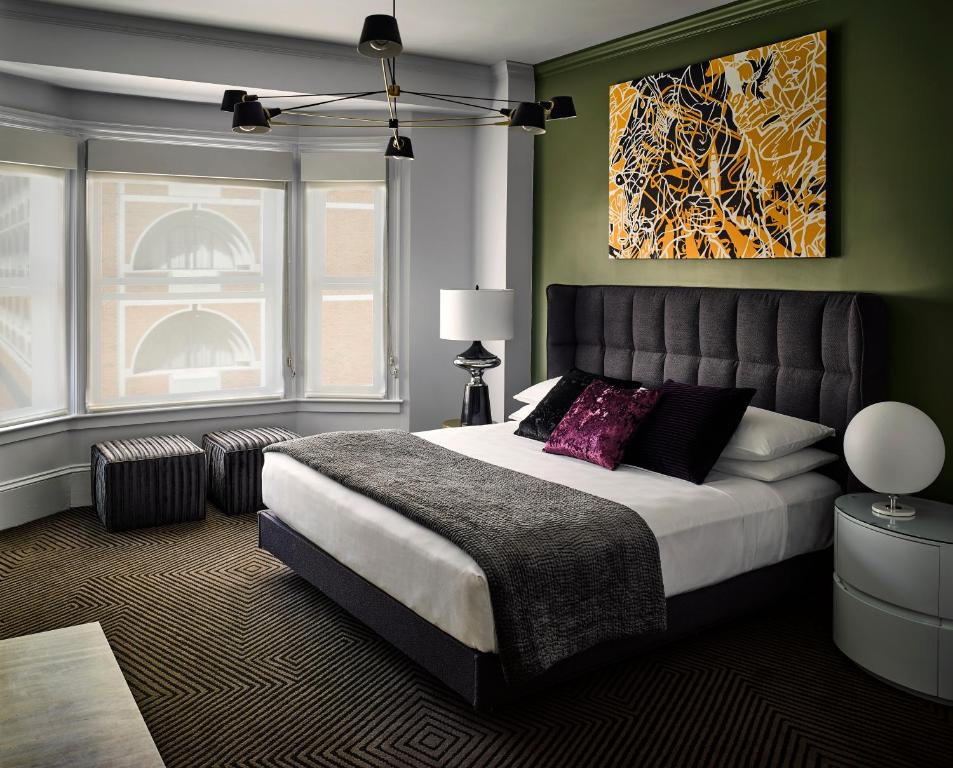 a bedroom with a bed and a painting on the wall at Hotel Zeppelin San Francisco in San Francisco