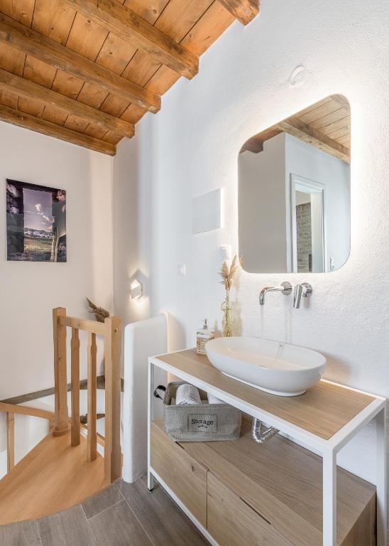 a bathroom with a sink and a mirror at Studios Betty in Plaka Milou