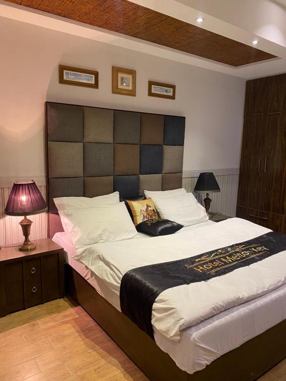 1 dormitorio con 1 cama grande y cabecero grande en comfort you deserve, en Islamabad