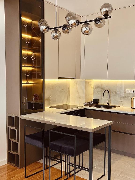 a kitchen with a sink and a counter with stools at Vista in Trebinje