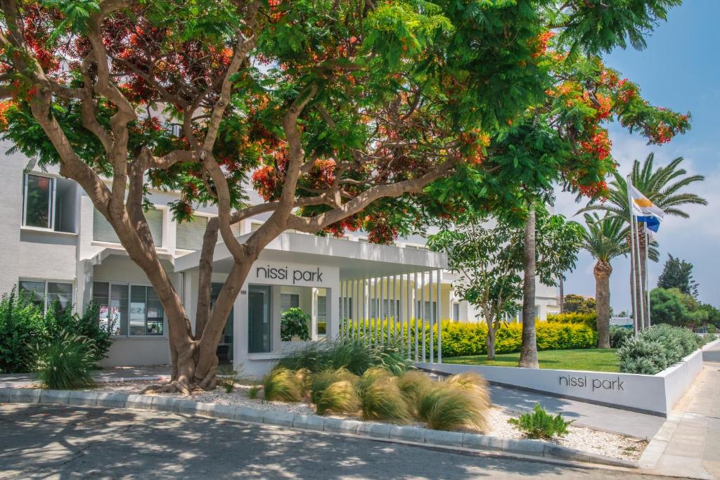 a building with a tree in front of it at Nissi Park Hotel in Ayia Napa