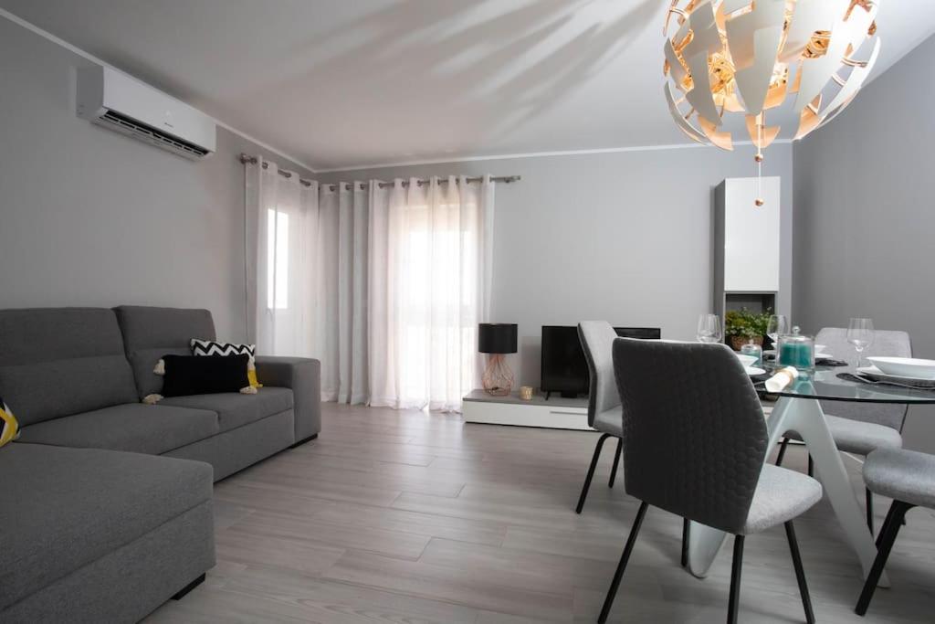 a living room with a couch and a table at Apartamento Janelas da Ria in Faro