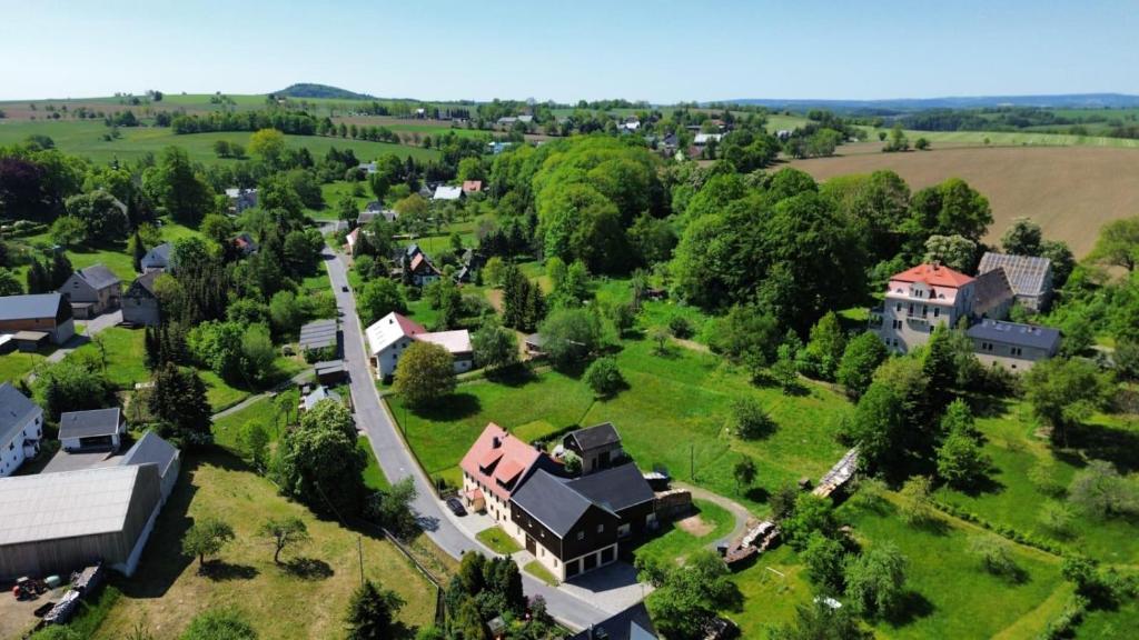 an aerial view of a house in a green field at Ferienwohnung Aus-Zeit auf dem Lande in Bad Gottleuba