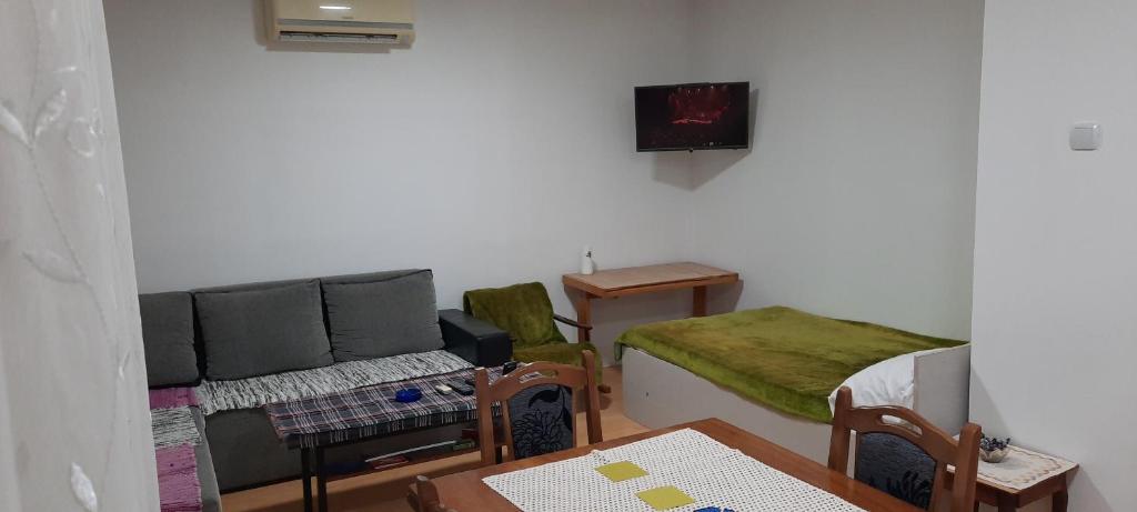 a living room with a couch and a table at Apartman Boba in Ruma