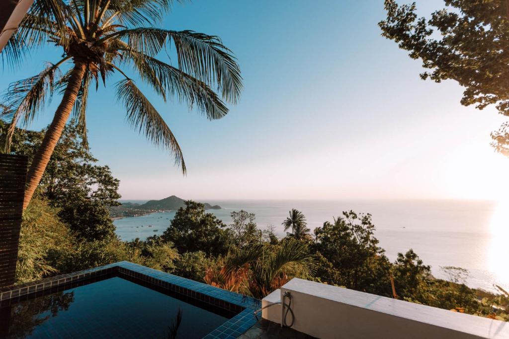 a swimming pool with a view of the ocean at Lunar Villas Koh Tao - Luxury Private Pool Villas in Ko Tao