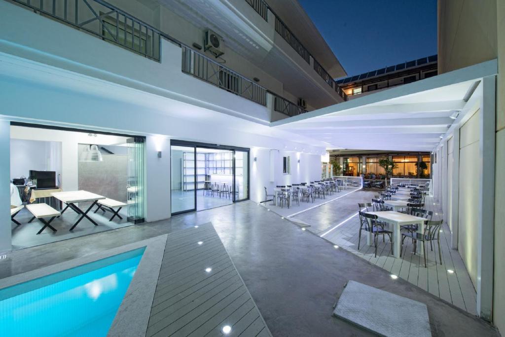 a large building with a pool and tables and chairs at Fedra Boutique Apartments in Hersonissos