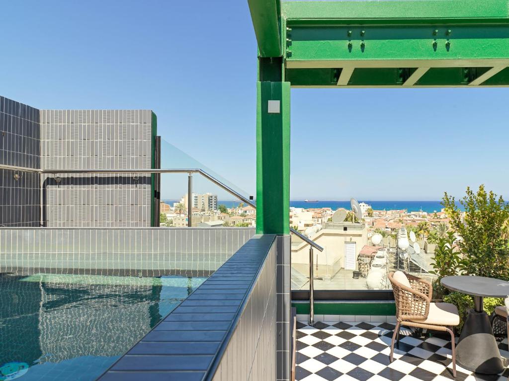 a balcony with a swimming pool on top of a building at Maestro St Lazar Apartments in Larnaca