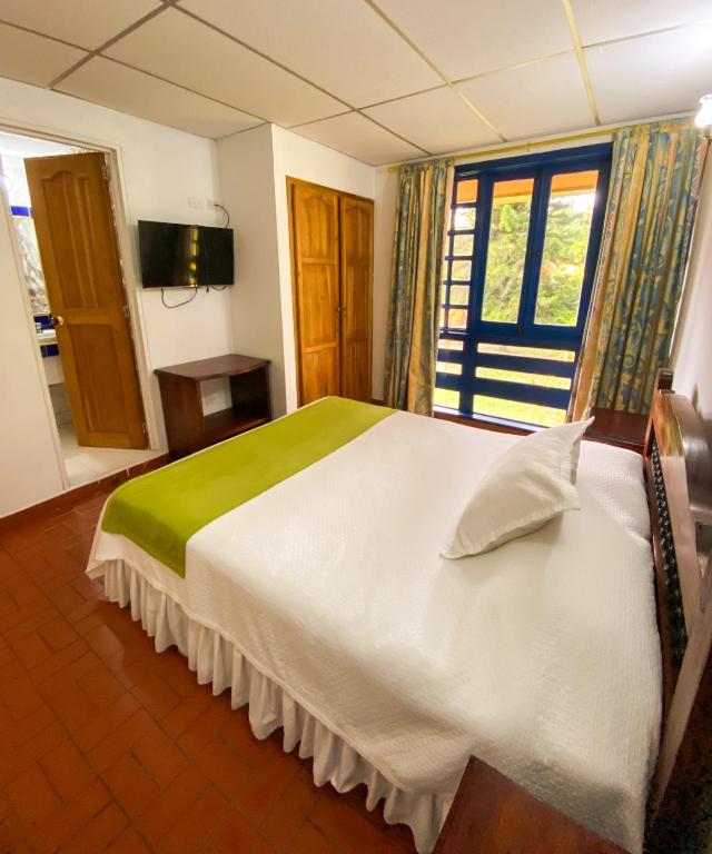 Voodi või voodid majutusasutuse Ecohotel La Casona Pereira toas
