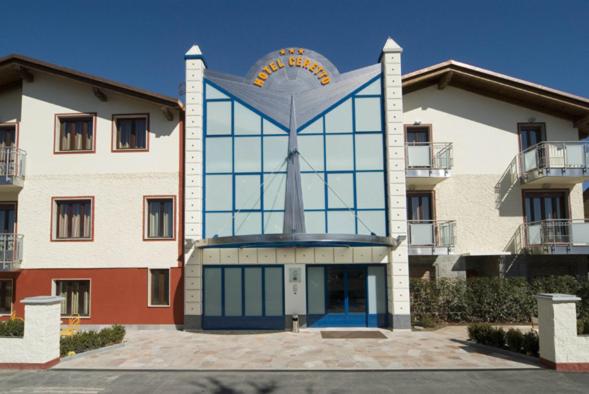 a large building with a clock on top of it at Hotel Ceretto in Busca