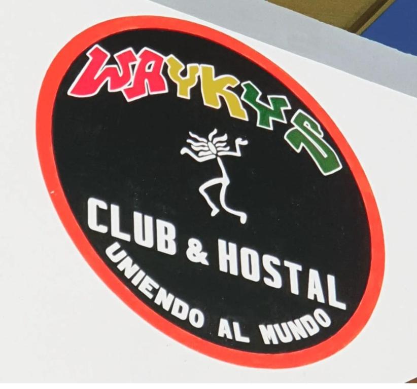 a sign for a club and hostel at Wayky's Club and Hostal in Copacabana