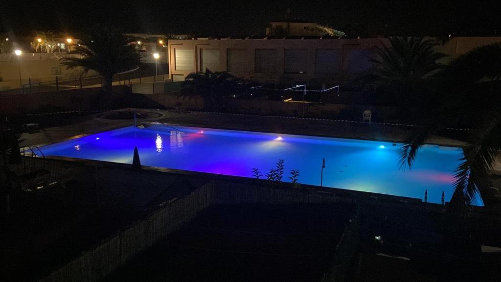 uma grande piscina à noite com luzes azuis em Villa Costa Antigua A3 em Costa de Antigua