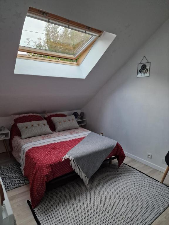 a bedroom with a bed with a red blanket and a window at Chambre aux Gorges de Daluis in Guillaumes