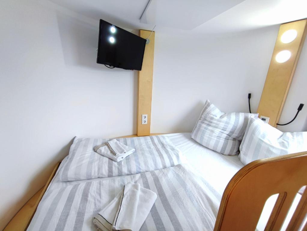 ein kleines Schlafzimmer mit einem Bett und einem TV in der Unterkunft Tiny House Ückeritz in Ückeritz