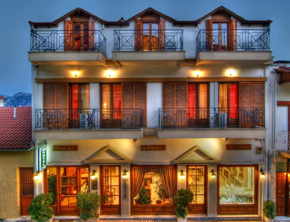 an apartment building with balconies and lights at Pan Hotel in Delphi