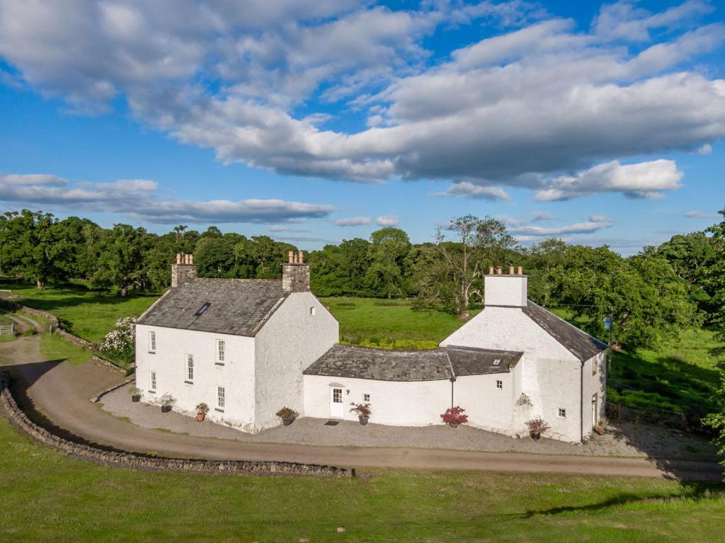 an aerial view of a white building in a field at Airds of Kells House in Castle Douglas