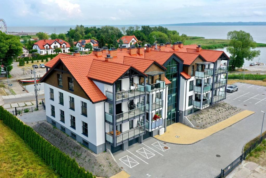 an aerial view of a building with an orange roof at PORT KRYNICA Apartamenty in Krynica Morska