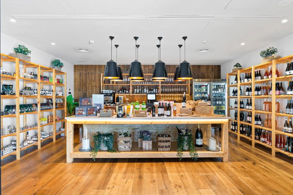 a store with a counter and shelves of alcohol at Las Terrazas de Abama Suites in Guía de Isora
