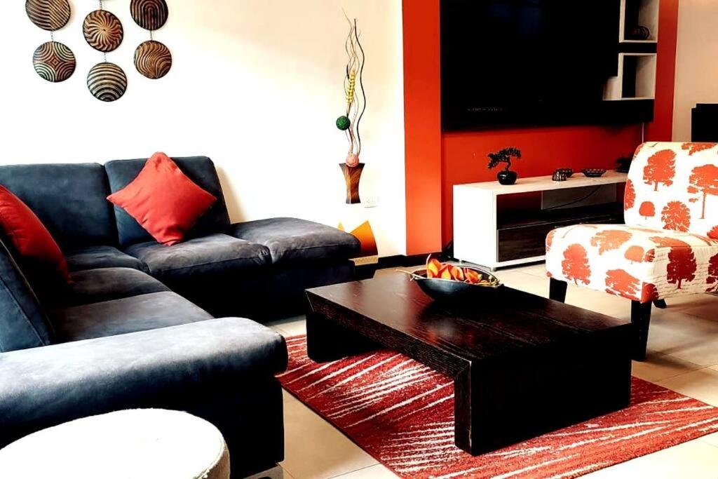 a living room with two couches and a coffee table at Bonita casa en sector residencial al norte de Loja in Loja