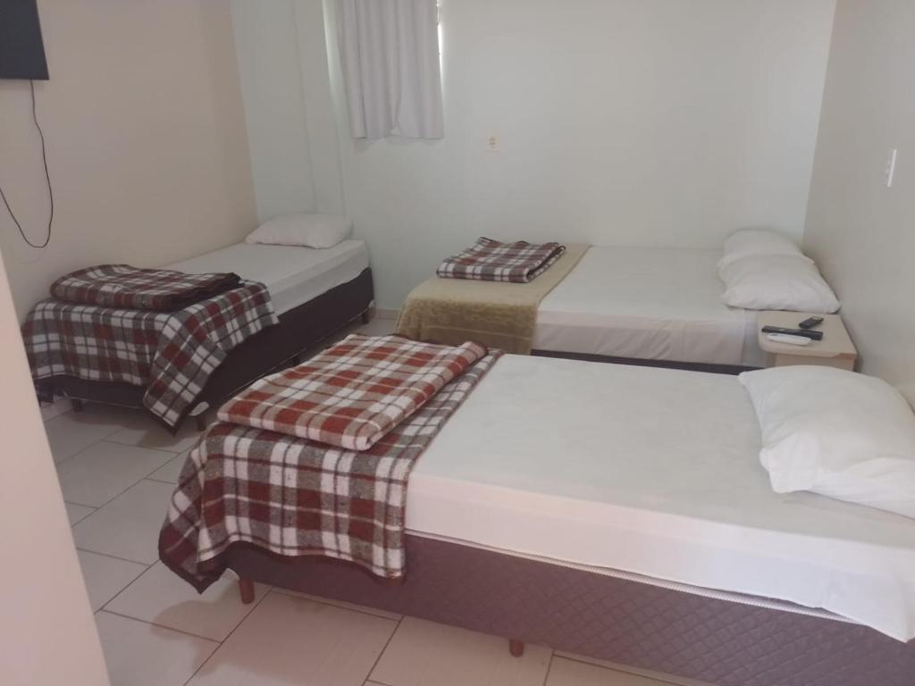 Postel nebo postele na pokoji v ubytování Hotel Alvorada