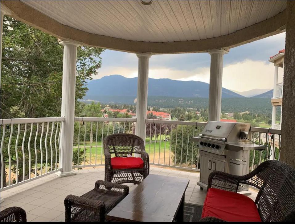 a porch with a table and chairs and a stove at Mountain View Vacation Villa Main Floor Unit, No Stairs in Fairmont Hot Springs
