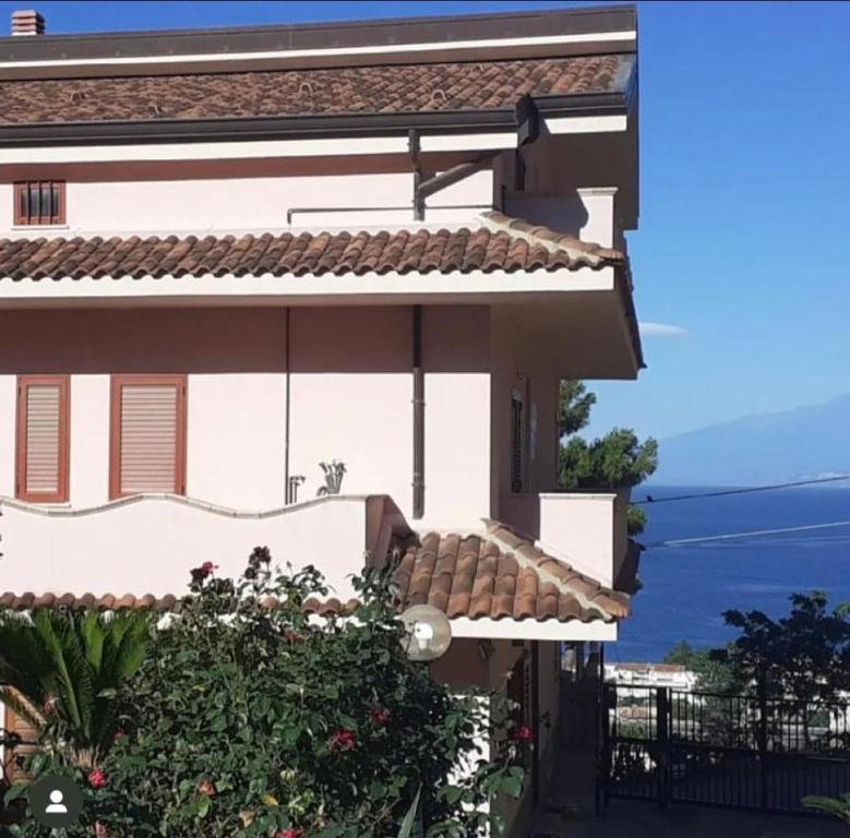a house with a view of the ocean at Campolo Apartment in Reggio Calabria