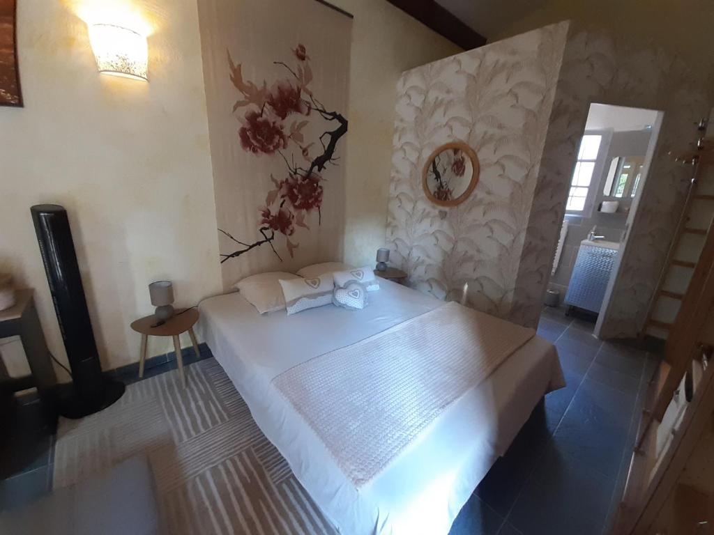 a bedroom with a large white bed in a room at La Bergerie in Lorgues